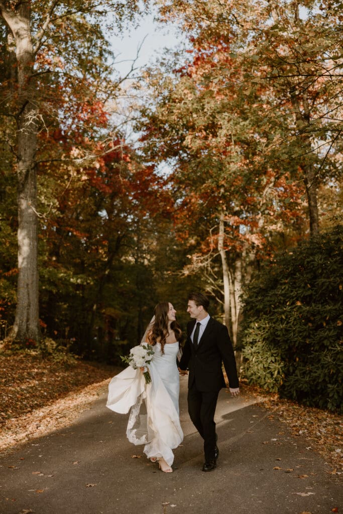 Romantic autumn elopement portraits overlooking colorful fall foliage
