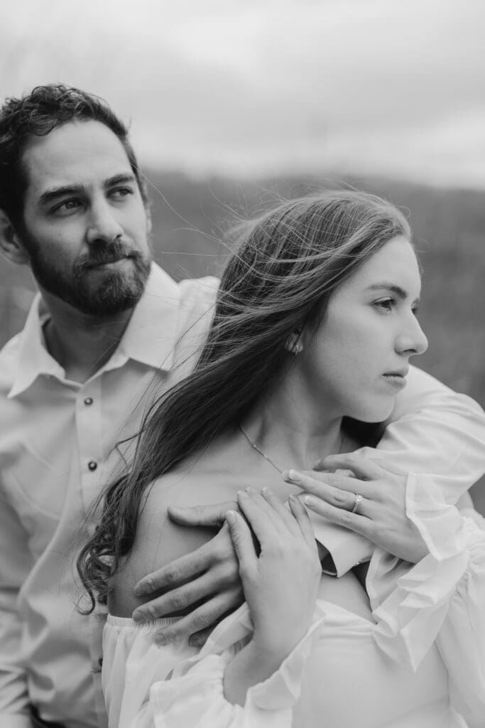 Natural candid engagement moment overlooking the mountains at Chapel at Pretty Place