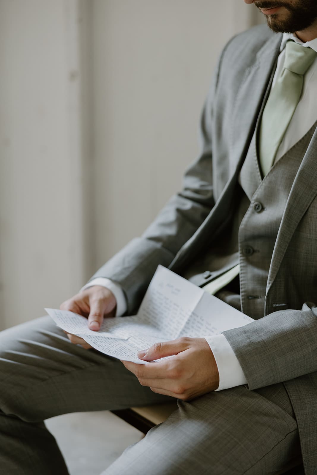Groomsmen reading letter