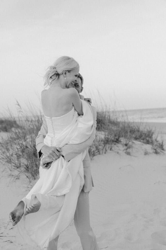 couple twirling and dancing on the sand at omni hilton head