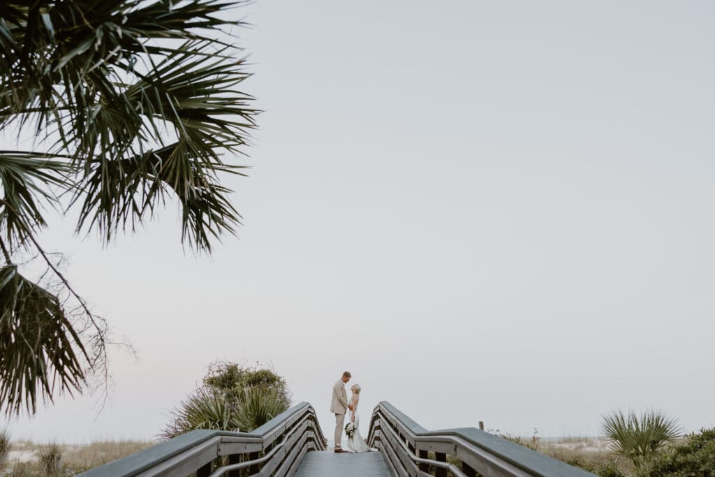 wide shot of couple on the pier outside of omni hilton head ocean front resort