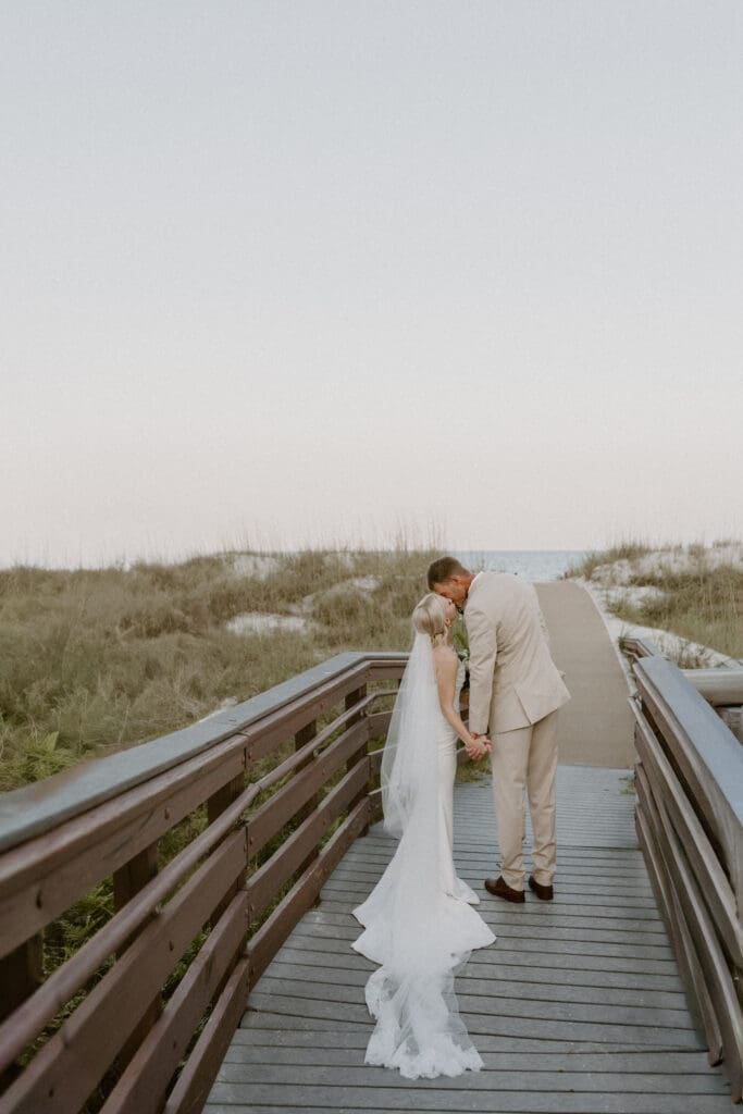 couple kiss on boardwalk at omni hilton head island sc
