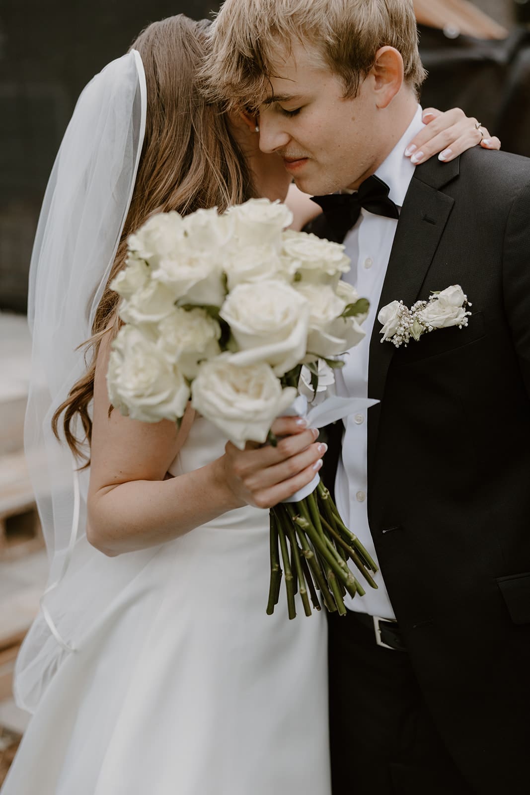 bride and groom exchange gifts and share an embrace