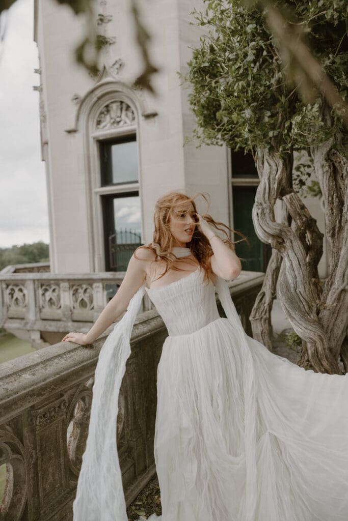 wind blows bride's anthropologie watters gown outside of biltmore estate asheville nc